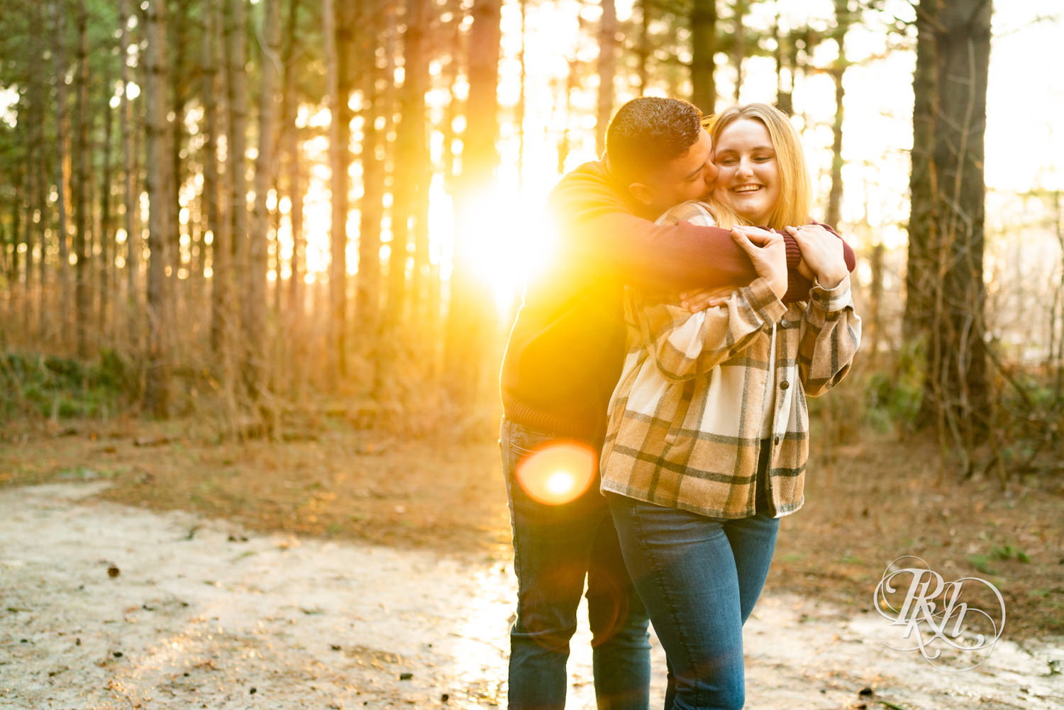 Filipino man and woman in flannel and jeans smile during sunset at Lebanon Hills in Eagan, Minnesota.