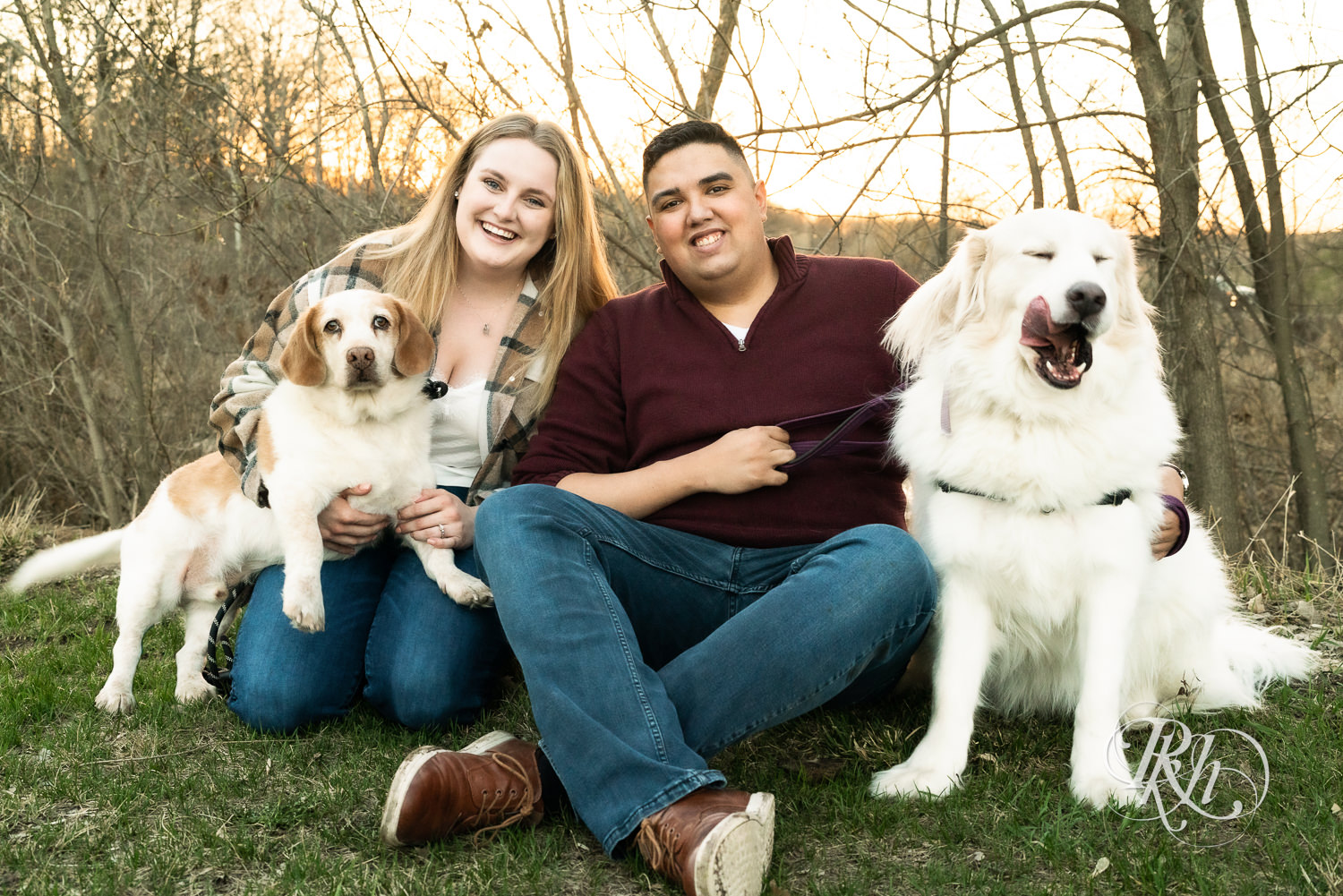 Filipino man and woman in flannel and jeans smile with their dogs at Lebanon Hills in Eagan, Minnesota.