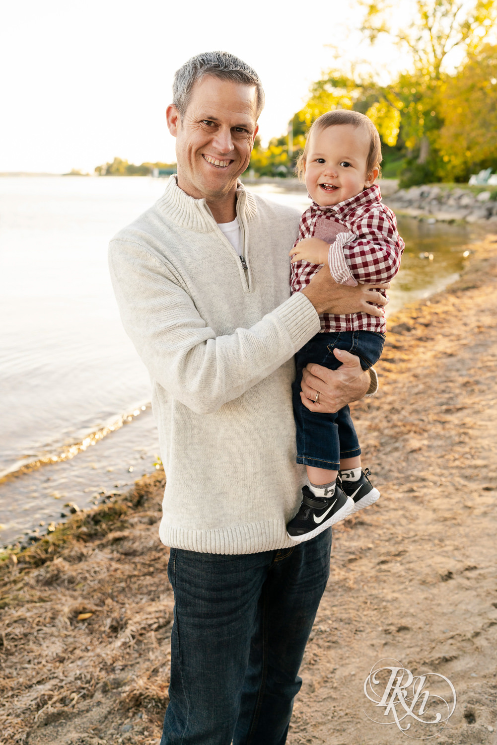 Dad and and baby son on Wayzata Beach in Minnesota.