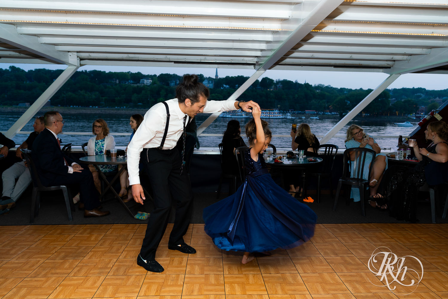 Grooms and guests dance during wedding reception on the Majestic Star by Stillwater River Boats in Stillwater, Minnesota.