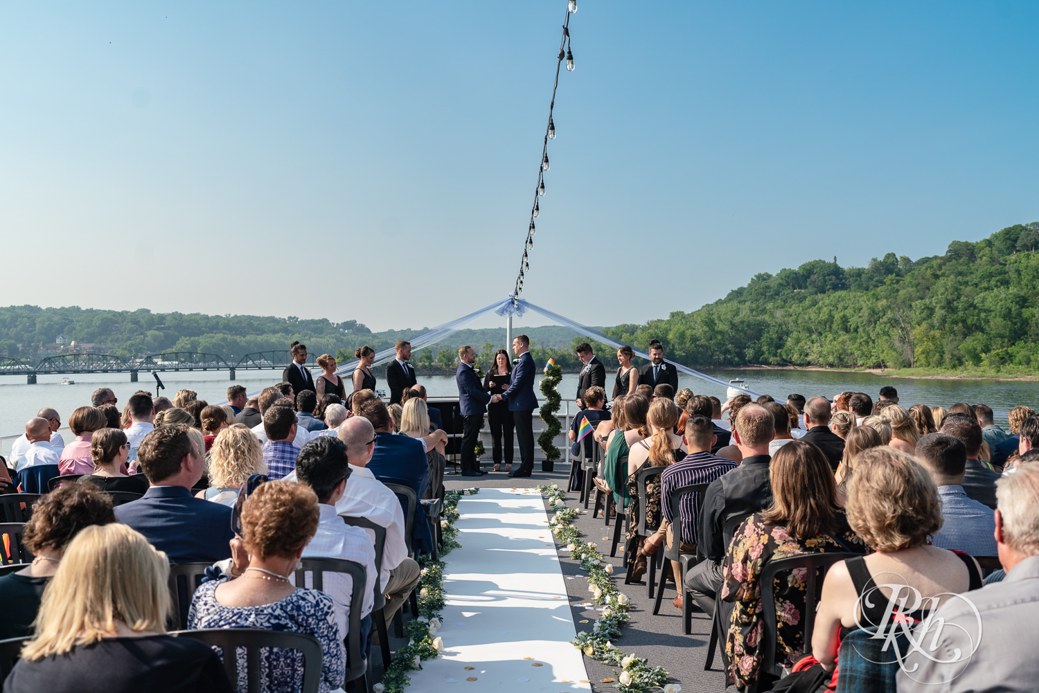 Grooms take part in wedding ceremony on the Majestic Star by Stillwater River Boats in Stillwater, Minnesota.