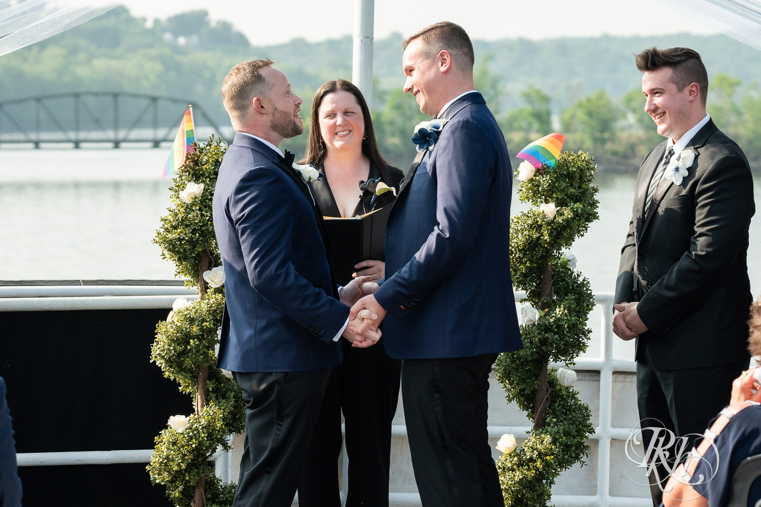 Grooms take part in wedding ceremony on the Majestic Star by Stillwater River Boats in Stillwater, Minnesota.