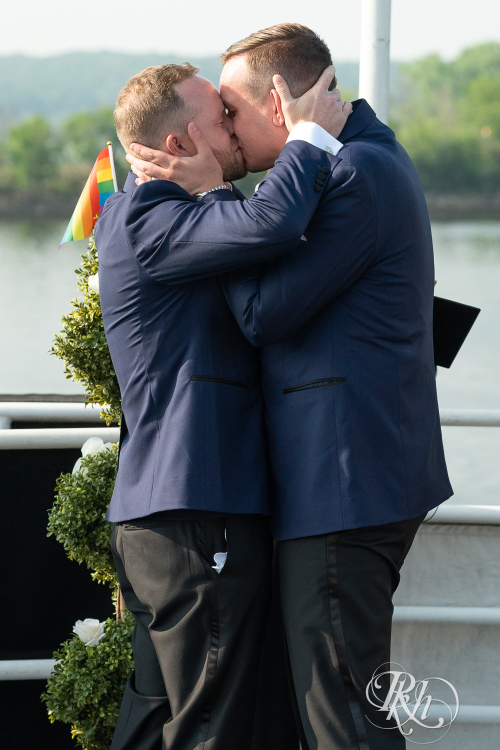 Grooms kiss after wedding ceremony on the Majestic Star by Stillwater River Boats in Stillwater, Minnesota.