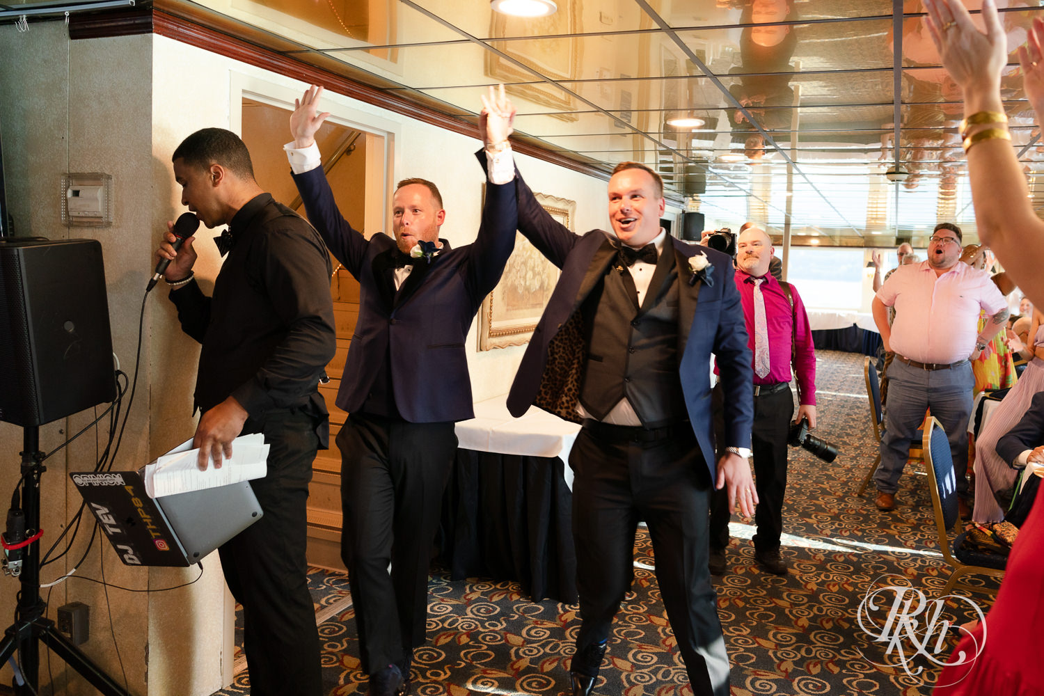 Grooms enter reception on the Majestic Star by Stillwater River Boats in Stillwater, Minnesota.