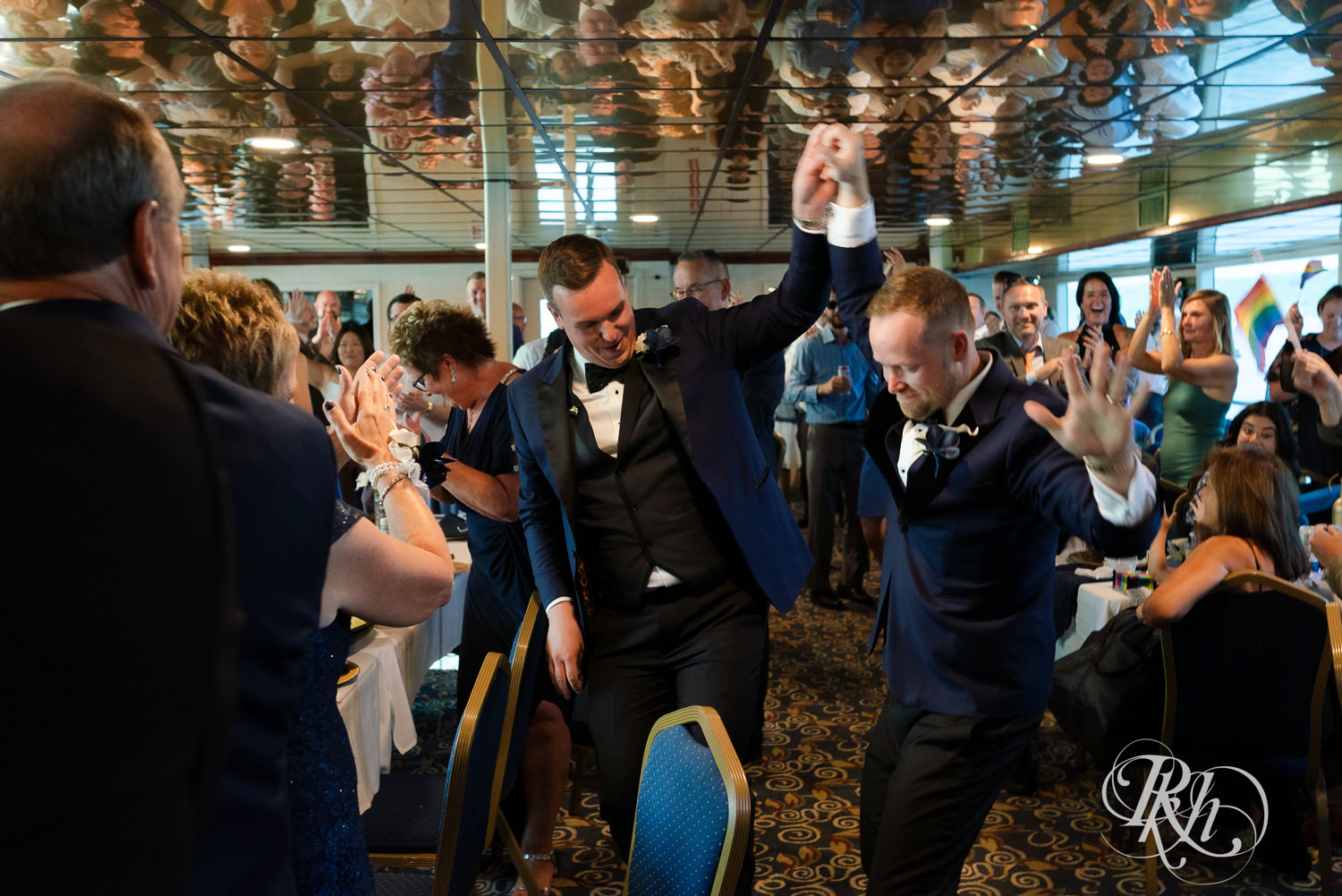 Grooms enter reception on the Majestic Star by Stillwater River Boats in Stillwater, Minnesota.
