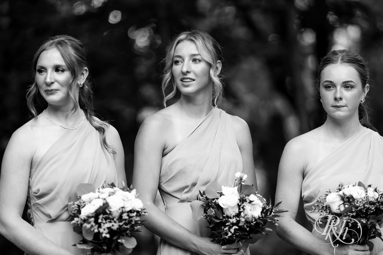 Bridesmaids watch bride come down aisle on wedding day at Ahavah Cottage in Elysian, Minnesota.