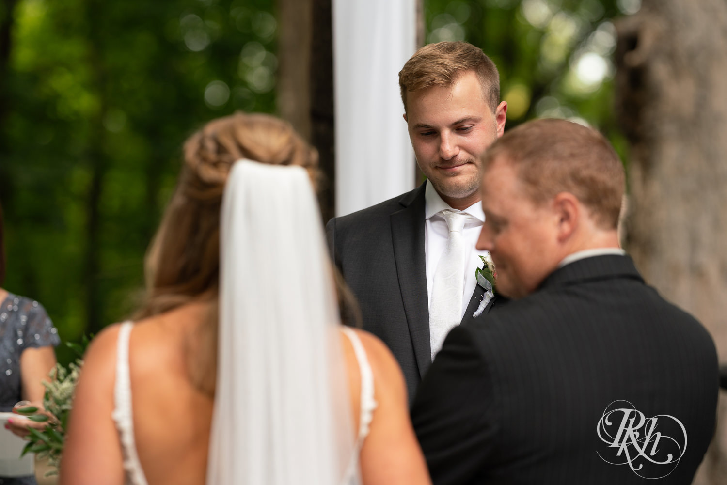 Groom sees bride walk down the aisle on wedding day at Ahavah Cottage in Elysian, Minnesota.