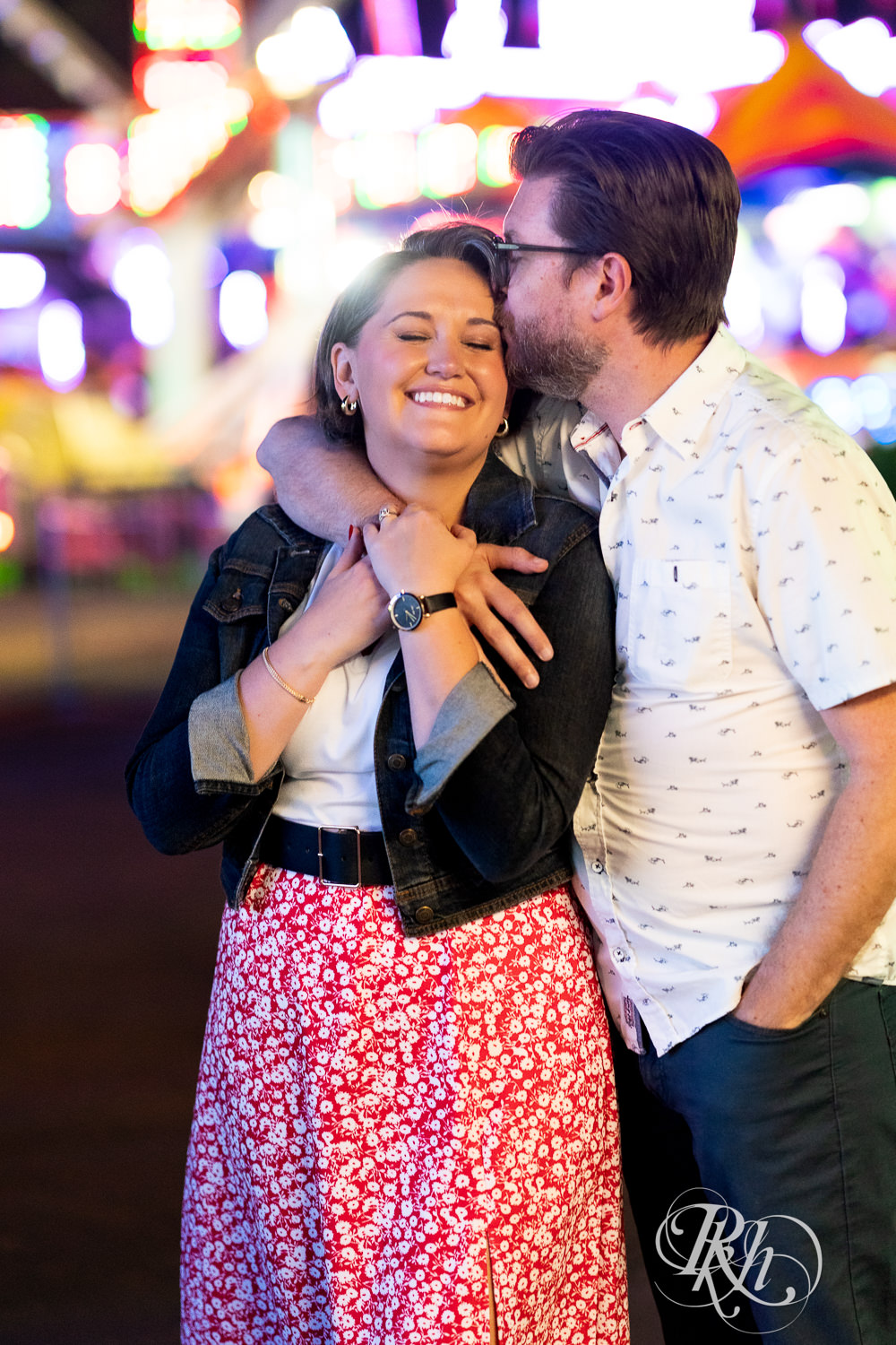 Man and woman kiss during their engagement photography at the Minnesota State Fair. 
