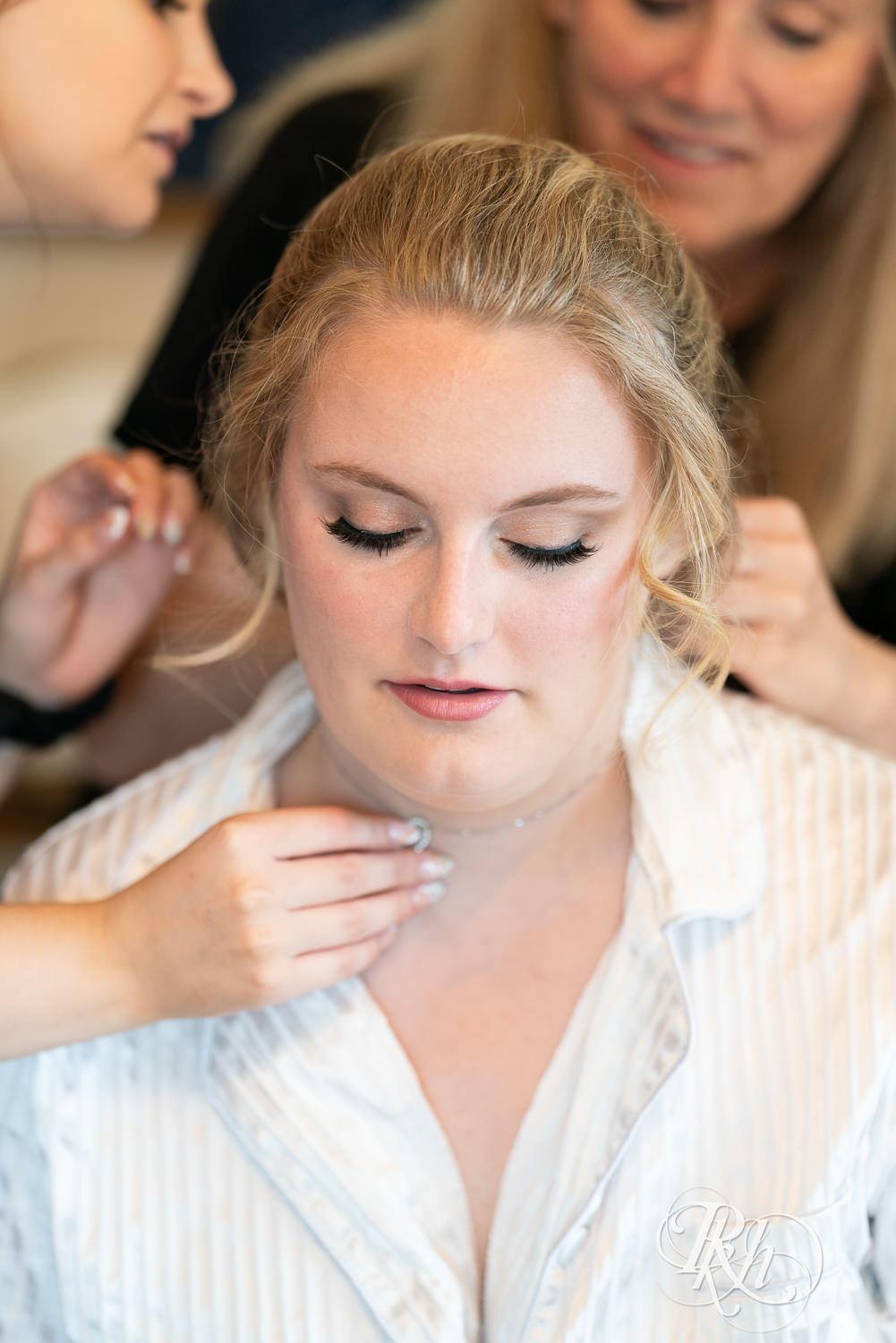 Bride getting hair and makeup done before wedding at Cottage Farmhouse in Glencoe, Minnesota.