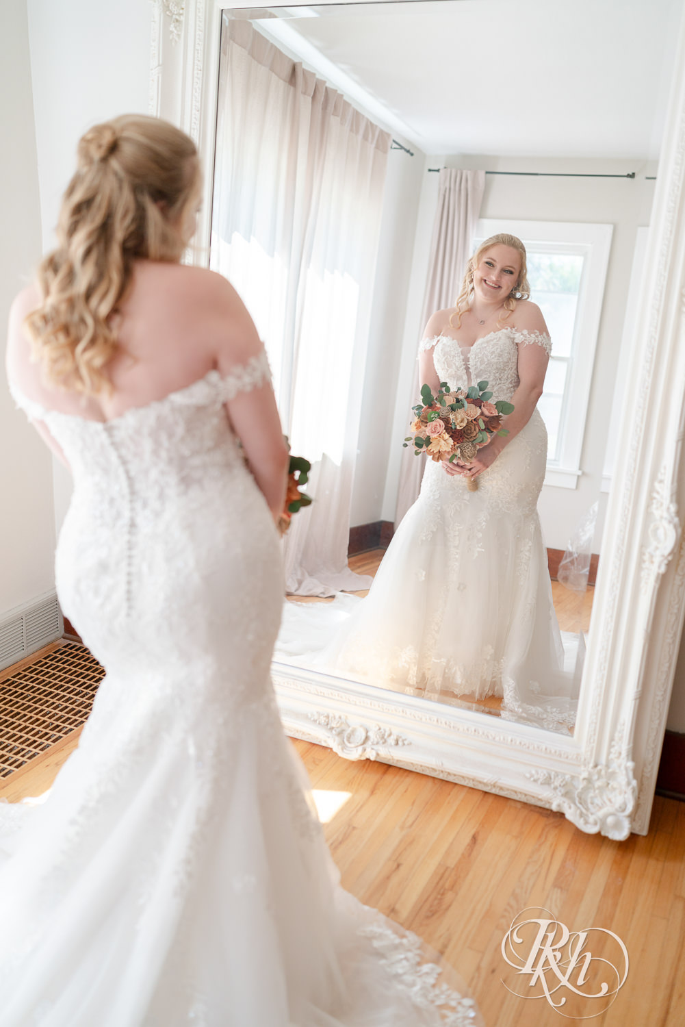Bride smiling after getting into wedding dress at Cottage Farmhouse in Glencoe, Minnesota.