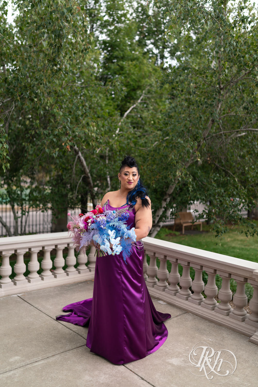 Filipino bride with mohawk dressed in purple wedding dress smiles at American Swedish Institute in Minnesota.