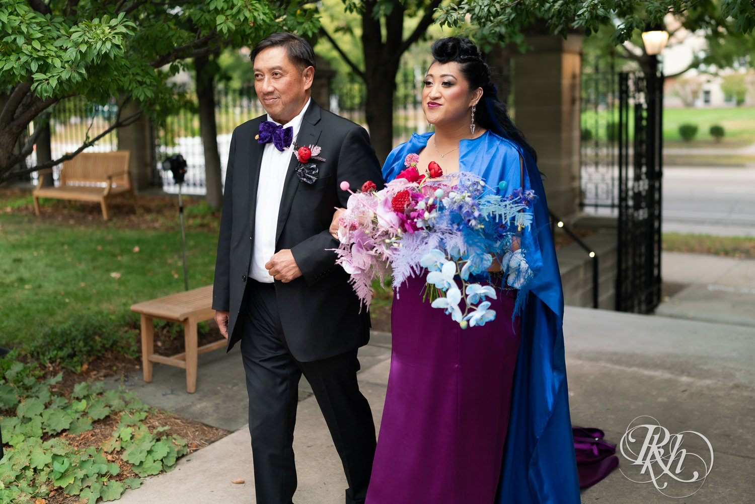 Filipino bride in purple wedding dress walks down the aisle at the American Swedish Institute in Minneapolis, Minnesota.