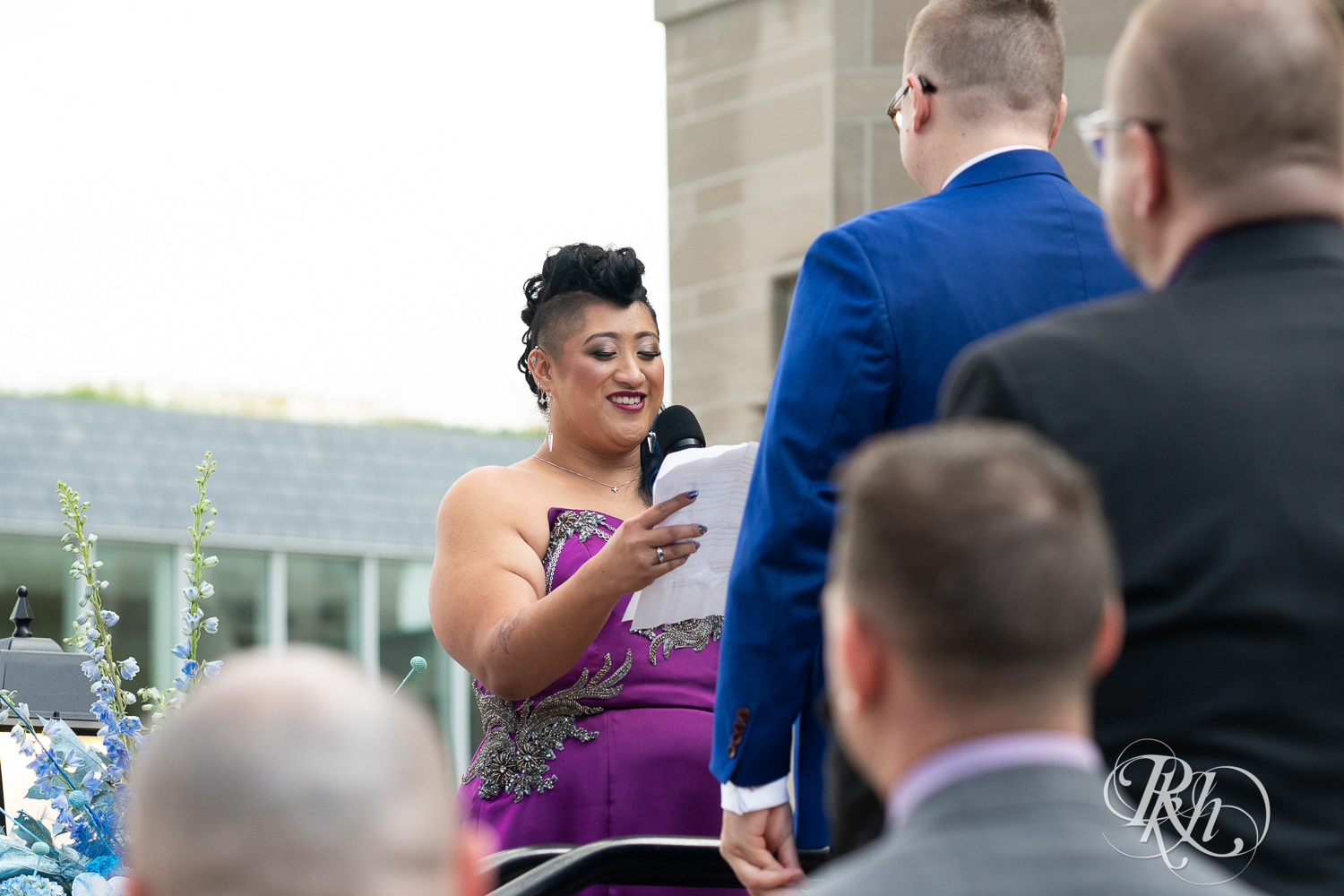 Filipino bride in purple wedding dress and groom read vows at wedding ceremony at the American Swedish Institute in Minneapolis, Minnesota.