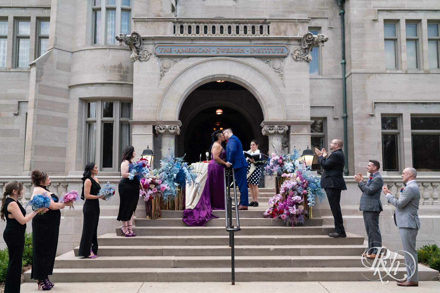 Filipino bride in purple wedding dress and groom kiss at wedding ceremony at the American Swedish Institute in Minneapolis, Minnesota.