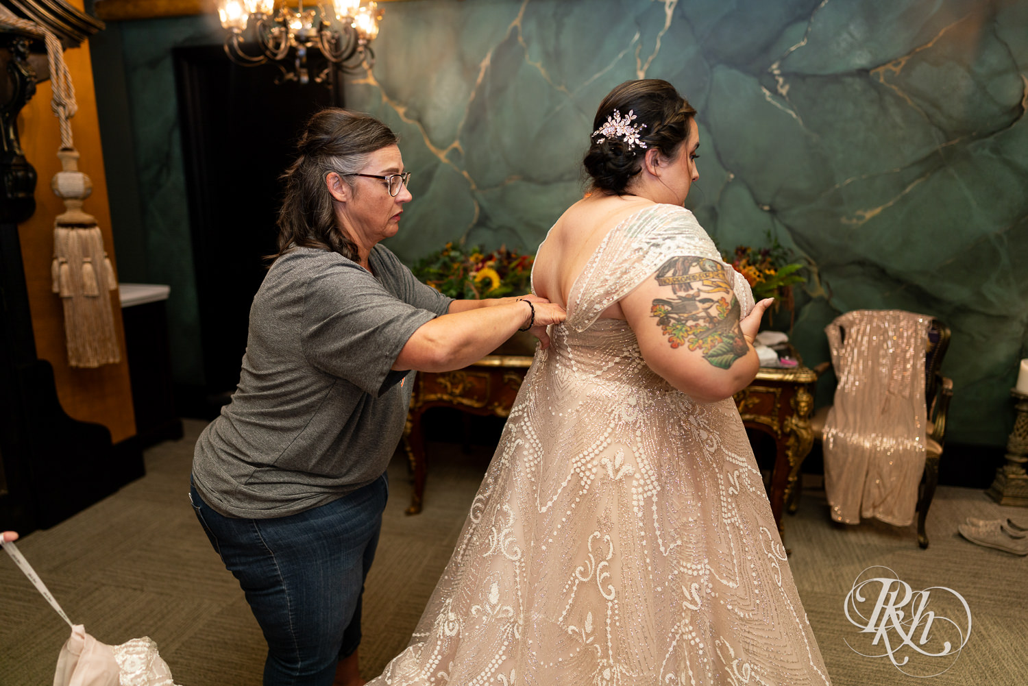 Plus size bride getting into dress at Kellerman's Event Center in White Bear Lake, Minnesota.