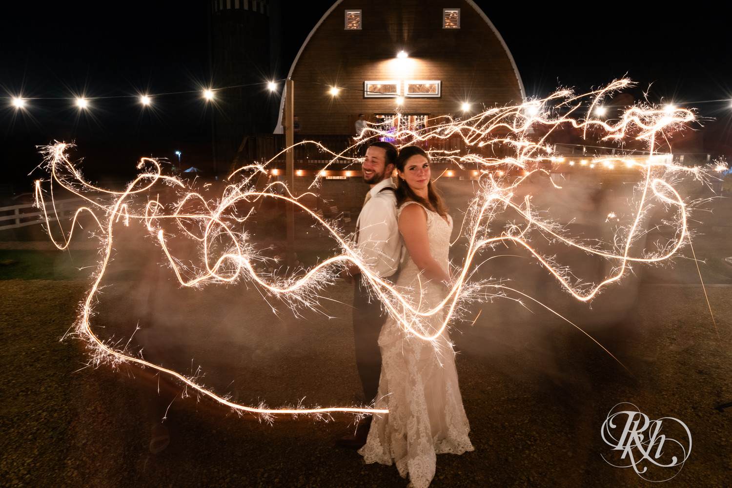 Bride and groom do a sparkler photo at Hayvn at Hay River in Boyceville, Wisconsin. 