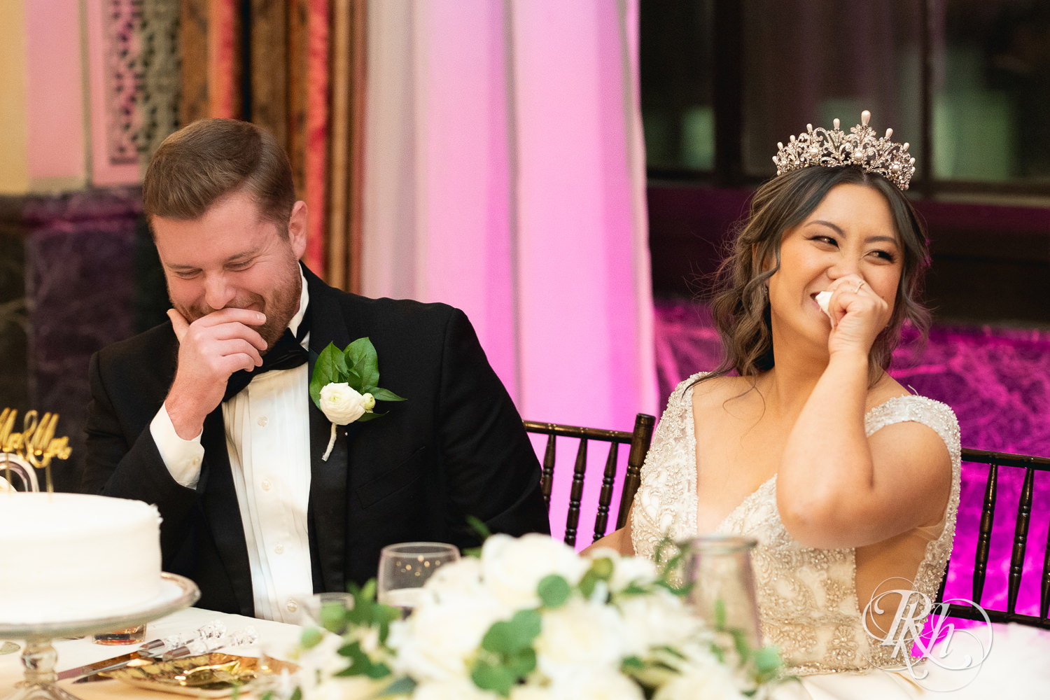 Bride, groom and guests smile during speeches at the Saint Paul Athletic Club in Saint Paul, Minnesota.
