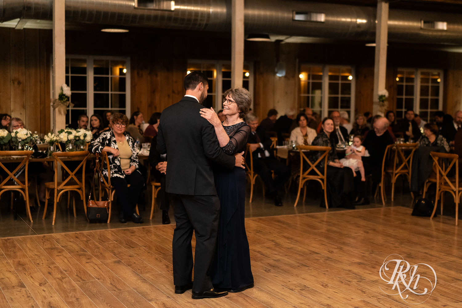 Groom and his mom dance at wedding reception at Almquist Farm in Hastings, Minnesota.