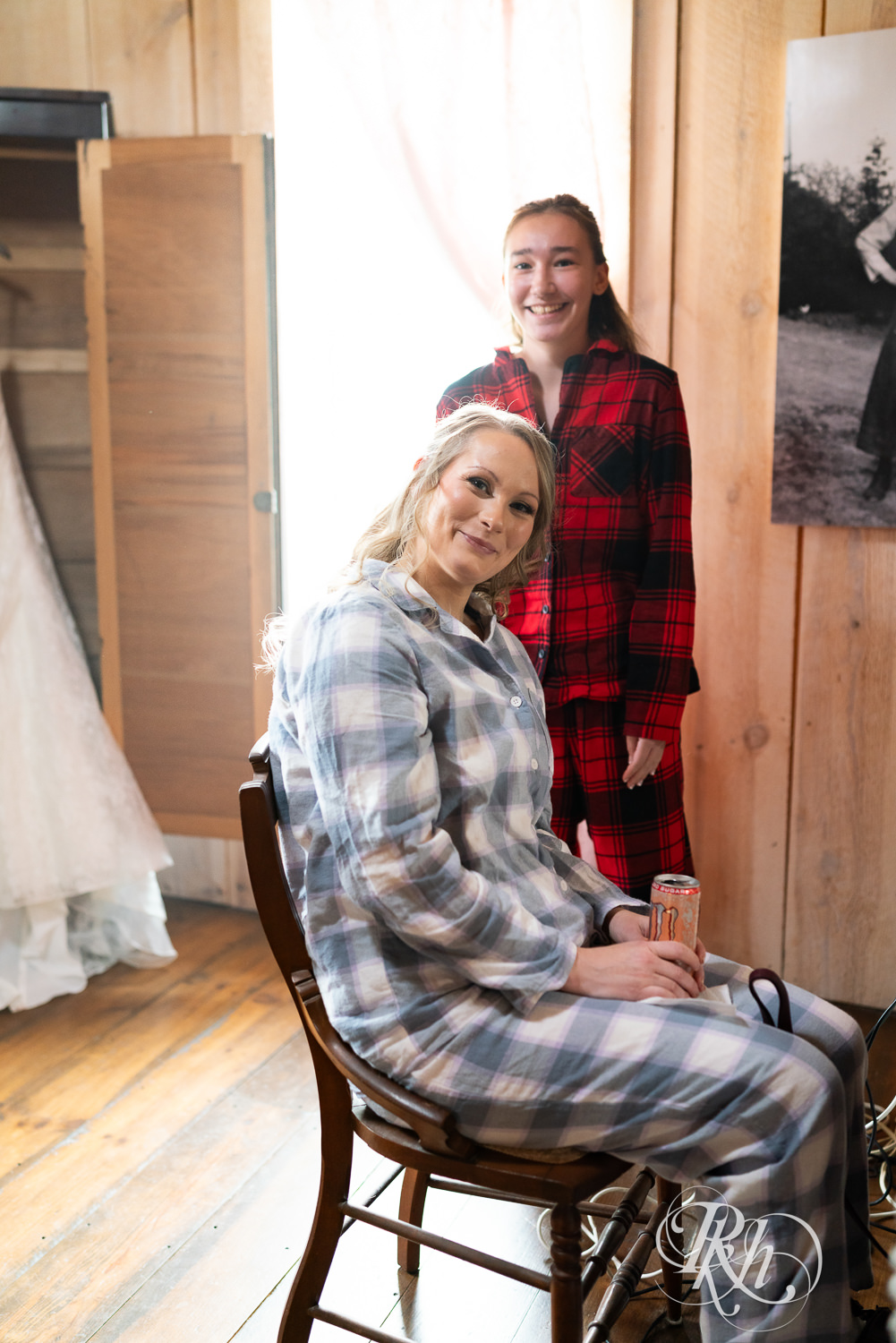 Bride gets hair and makeup done on wedding day at Almquist Farm in Hastings, Minnesota.
