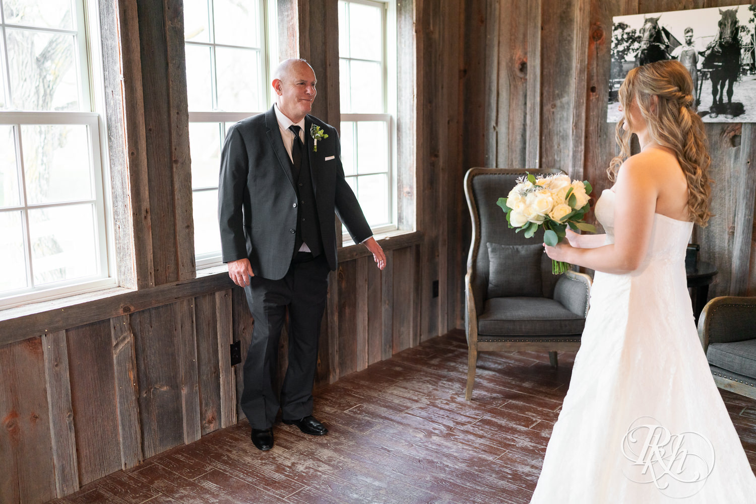 Bride does first look with her dad on wedding day at Almquist Farm in Hastings, Minnesota.