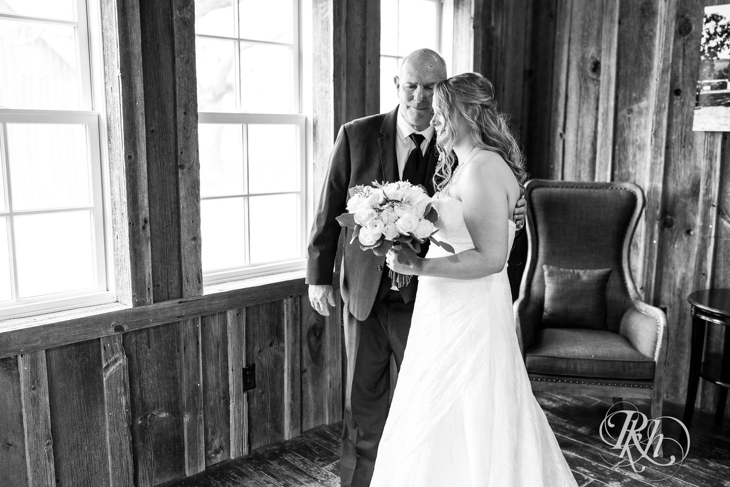 Bride does first look with her dad on wedding day at Almquist Farm in Hastings, Minnesota.