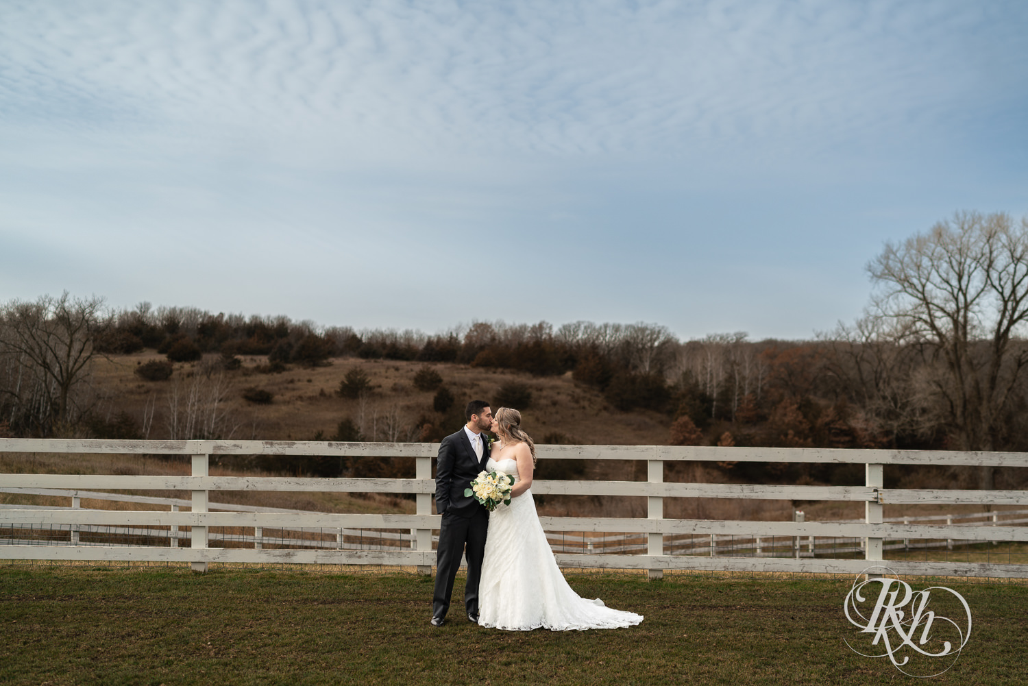 Bride and groom kiss on wedding day at Almquist Farm in Hastings, Minnesota.