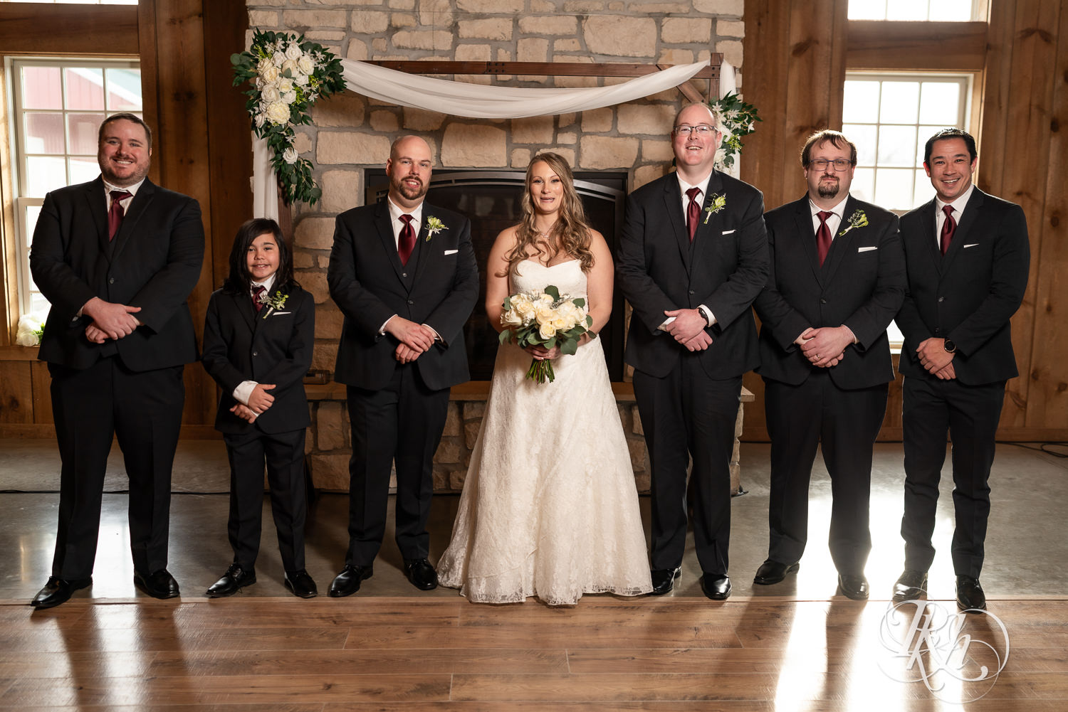 Bride smiles with wedding party at Almquist Farm in Hastings, Minnesota.