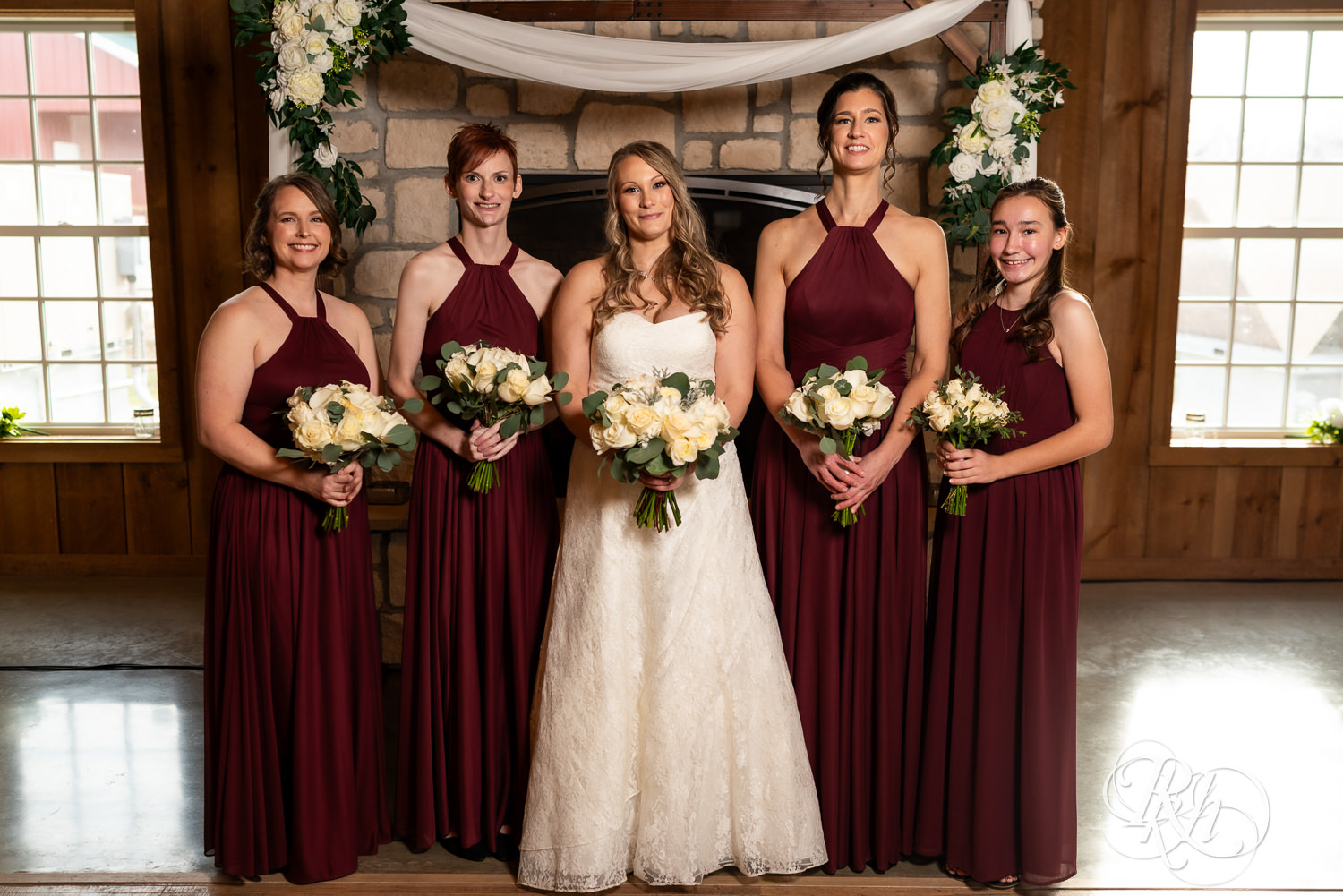 Bride smiles with wedding party at Almquist Farm in Hastings, Minnesota.