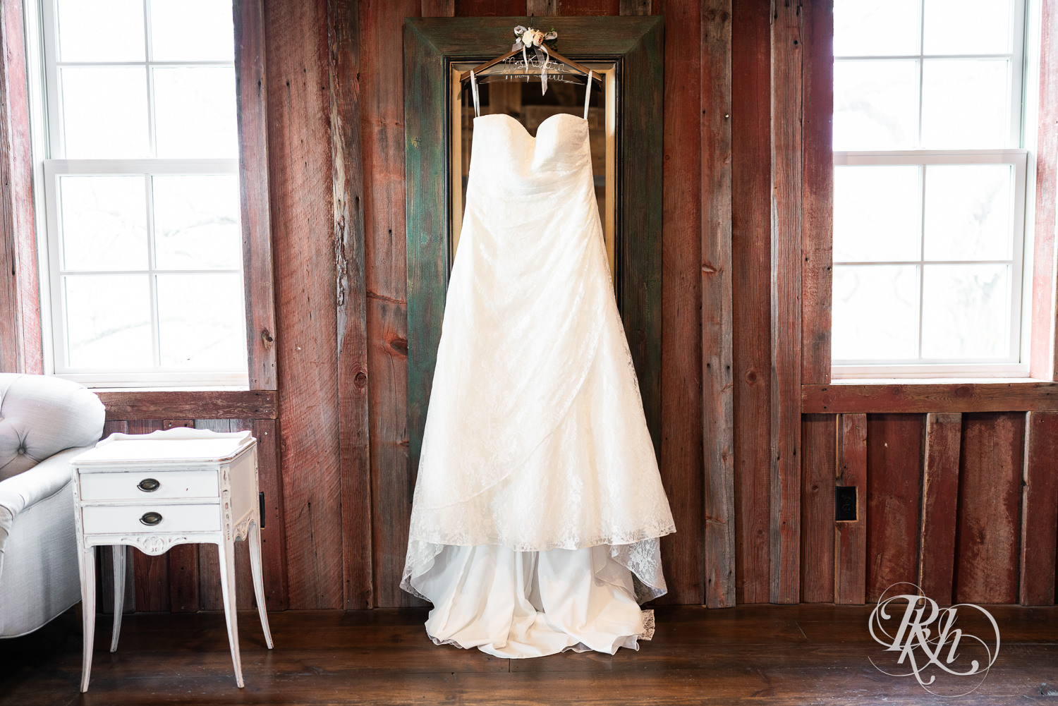 Wedding dress hangs on a mirror at Almquist Farm in Hastings, Minnesota.