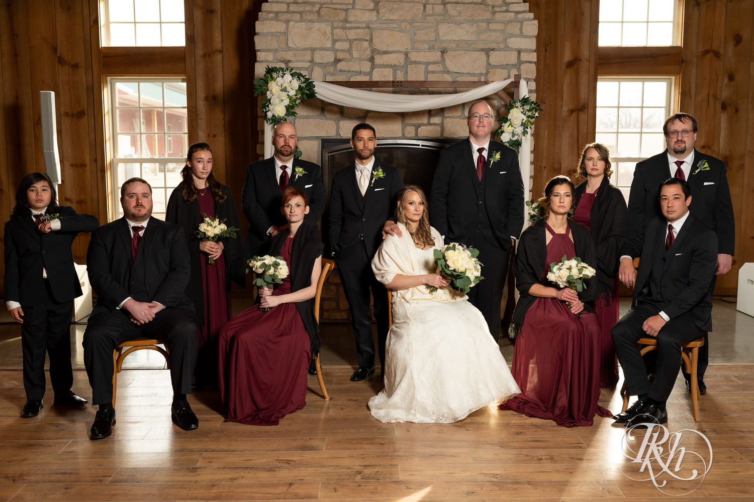 Bride and groom pose stoicly with wedding party at Almquist Farm in Hastings, Minnesota.