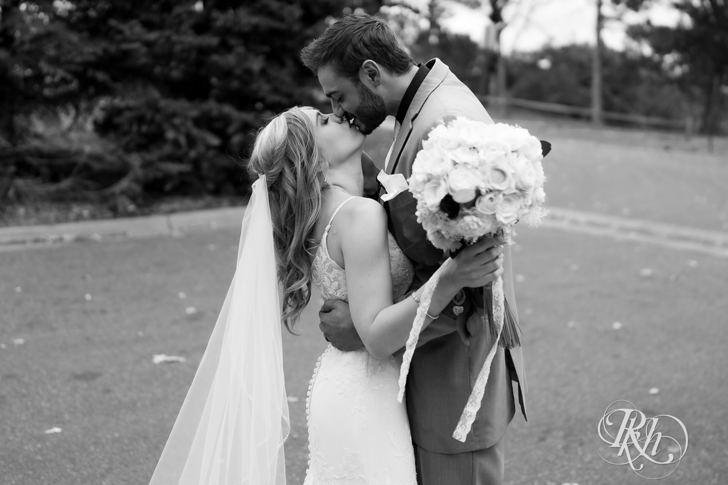 Bride and groom kiss after wedding ceremony at Bunker Hills Event Center in Coon Rapids, Minnesota.