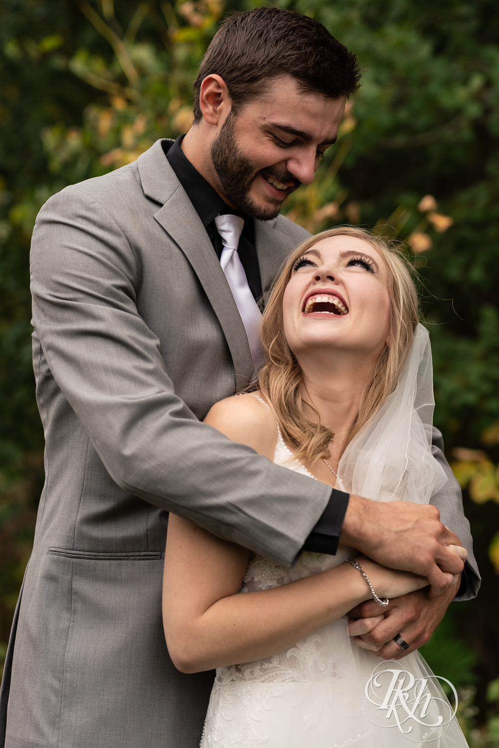 Bride and groom laugh on wedding day at Bunker Hills Event Center in Coon Rapids, Minnesota.