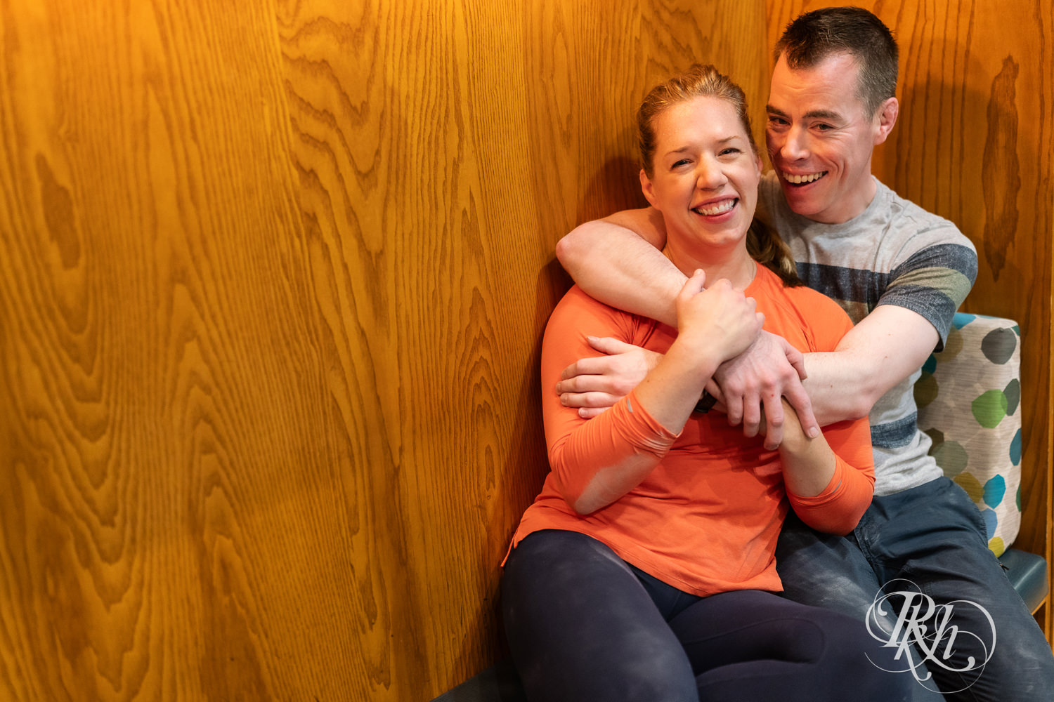 Man and woman smile during engagement photography session at the Bouldering Project in Minneapolis, Minnesota.