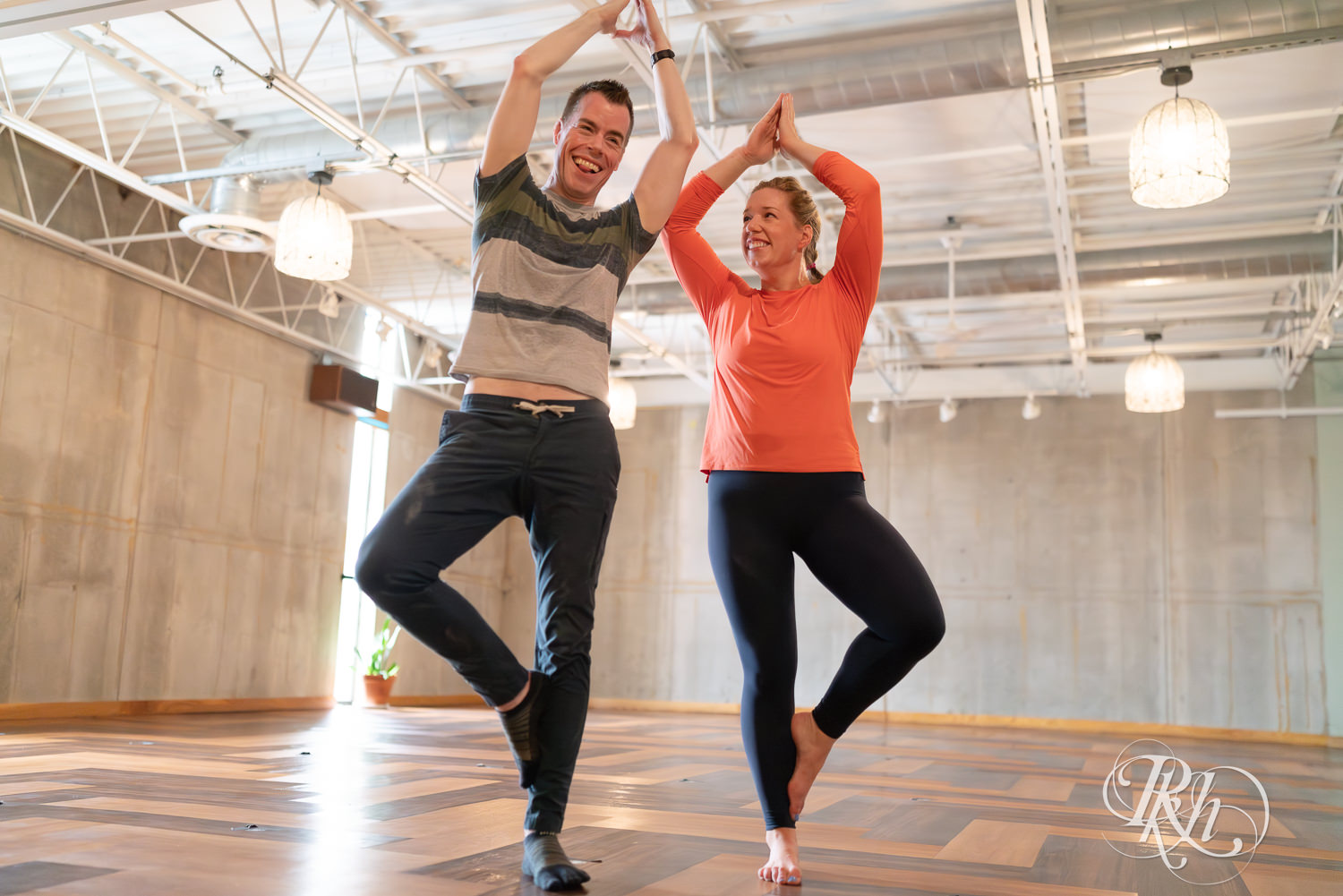 Man and woman smile in yoga studio at the Bouldering Project in Minneapolis, Minnesota.