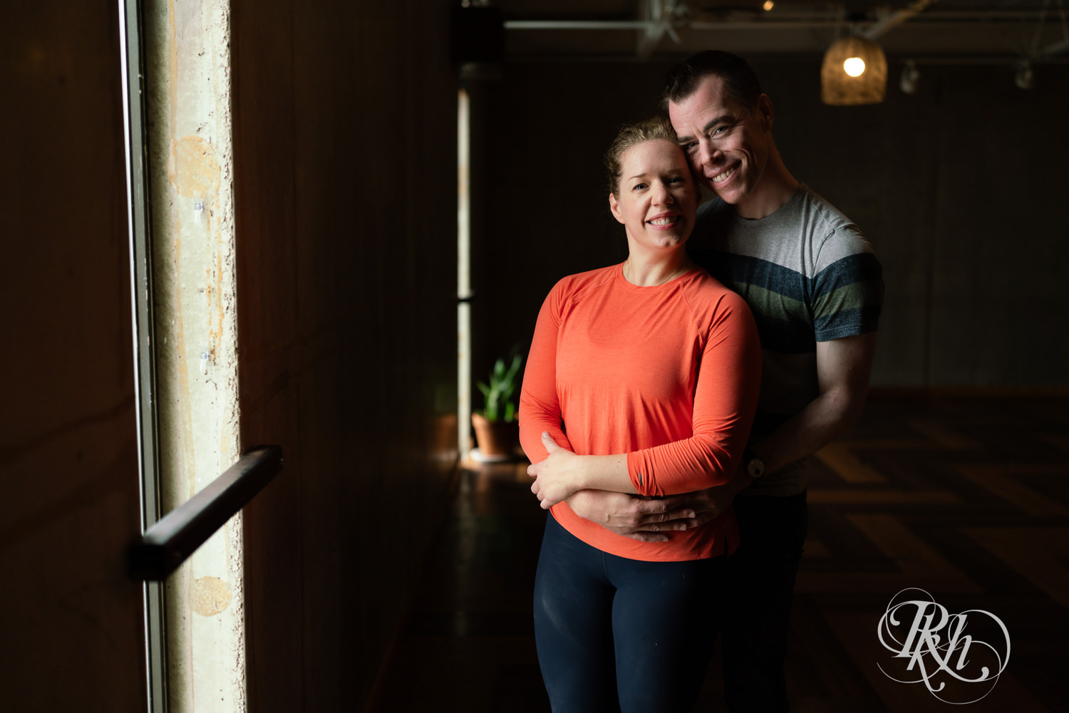 Man and woman smile in yoga studio at the Bouldering Project in Minneapolis, Minnesota.