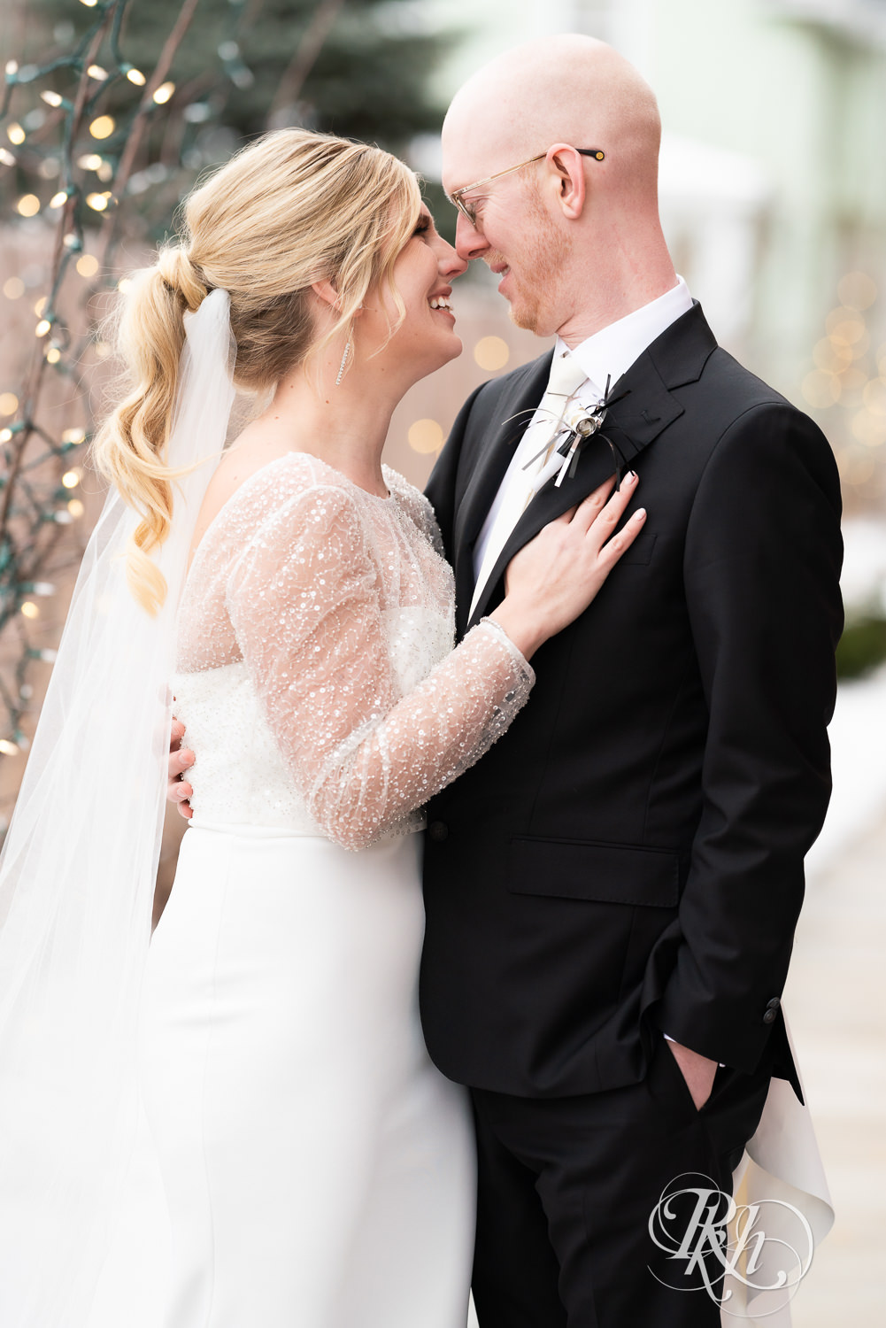 Bride and groom smile during winter wedding at Gatherings at Station 10 in Saint Paul, Minnesota.