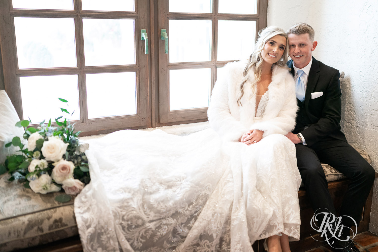 Bride and groom snuggle during winter wedding photography at Bavaria Downs in Chaska, Minnesota.