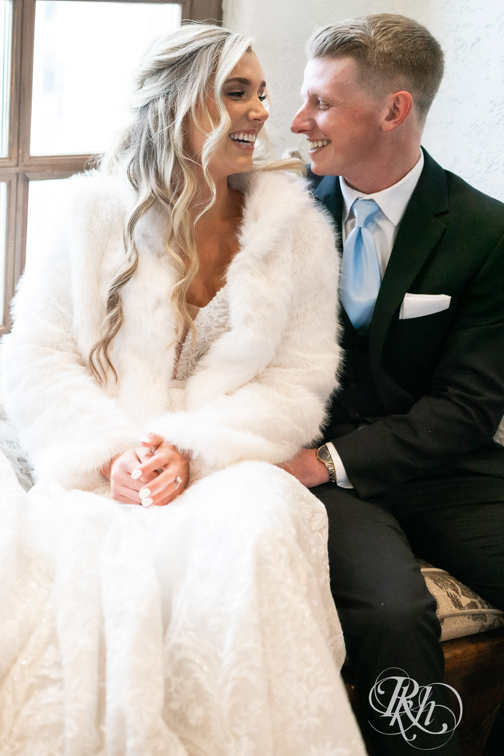 Bride and groom snuggle during winter wedding photography at Bavaria Downs in Chaska, Minnesota.