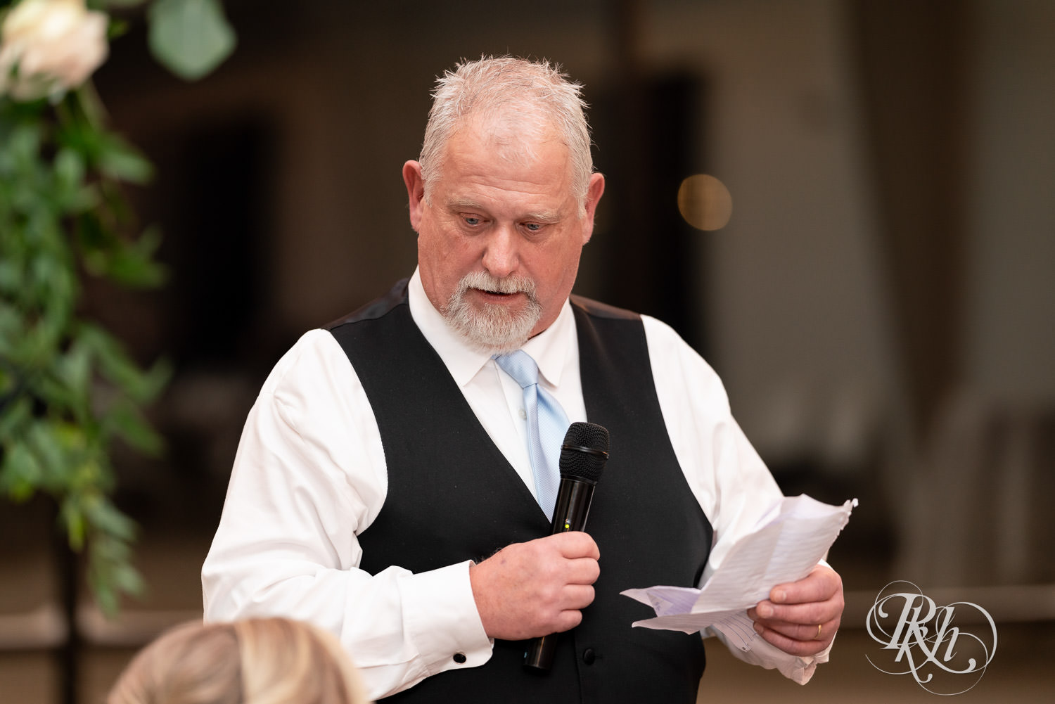 Father of groom smiles during speeches at wedding reception at Bavaria Downs in Chaska, Minnesota.