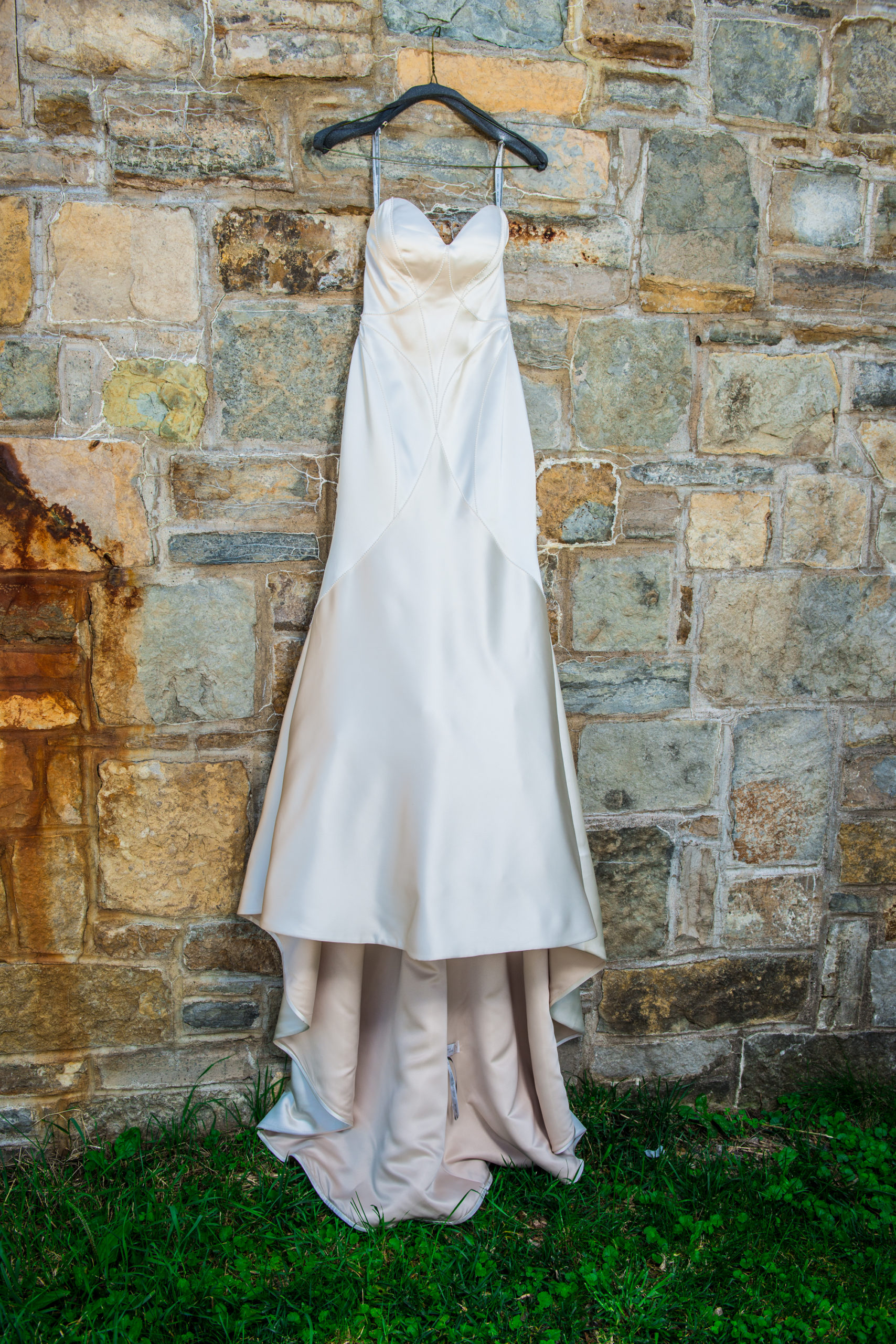 Wedding dress hanging on stone wall at Carpenter Nature Center in Hastings, Minnesota.