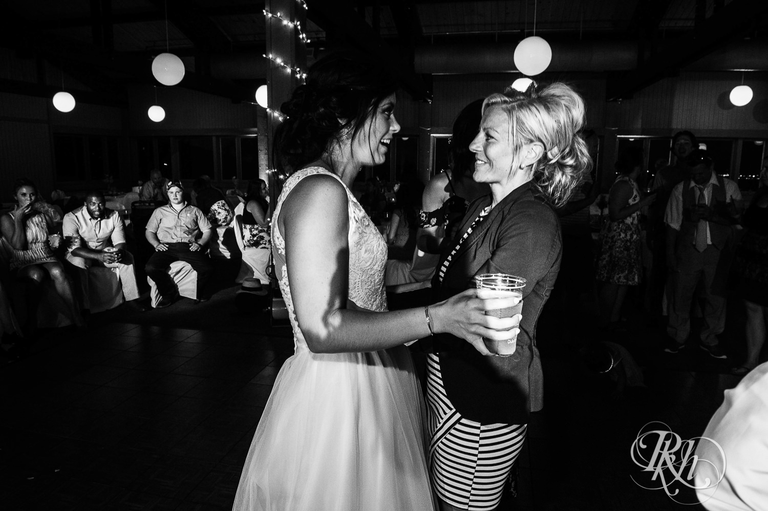 Lesbian brides and guests dance during their wedding reception at Spirit Mountain in Duluth, Minnesota.
