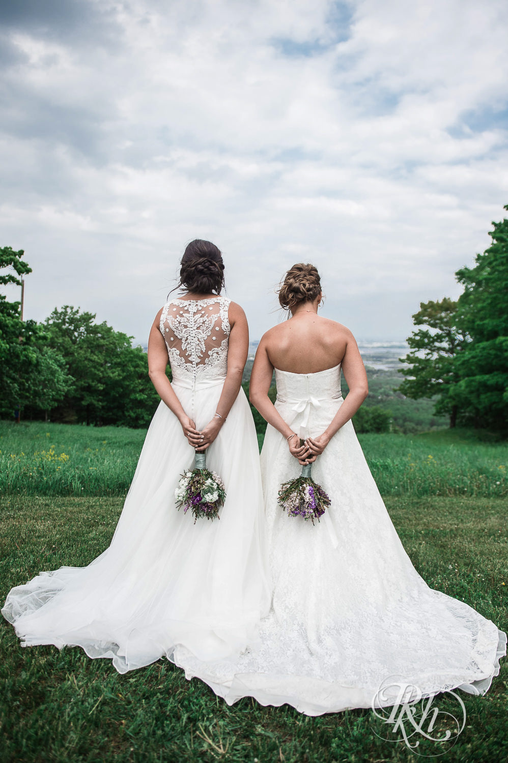 Lesbian brides hold bouquets at Spirit Mountain in Duluth, Minnesota.