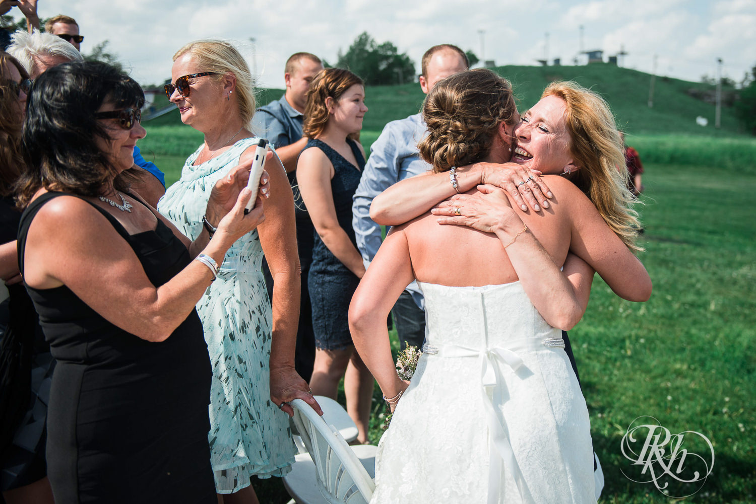 Lesbian brides hug guests at Spirit Mountain in Duluth, Minnesota.