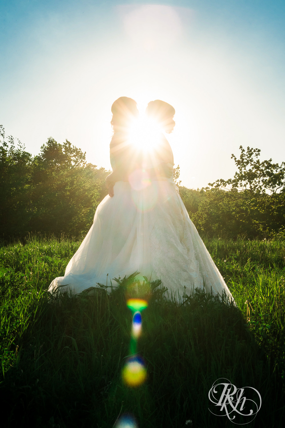 Lesbian brides kiss during sunset at Spirit Mountain in Duluth, Minnesota.