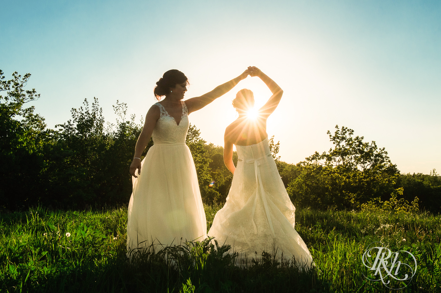 Lesbian brides dance during sunset at Spirit Mountain in Duluth, Minnesota.