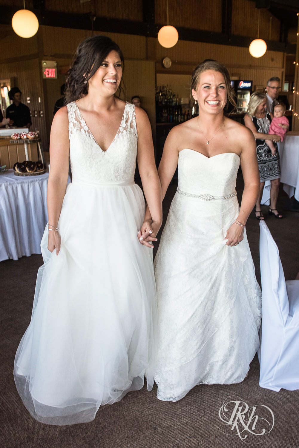 Lesbian brides enter their wedding reception at Spirit Mountain in Duluth, Minnesota.