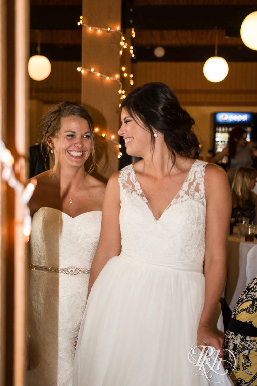 Lesbian brides smile during their wedding reception at Spirit Mountain in Duluth, Minnesota.