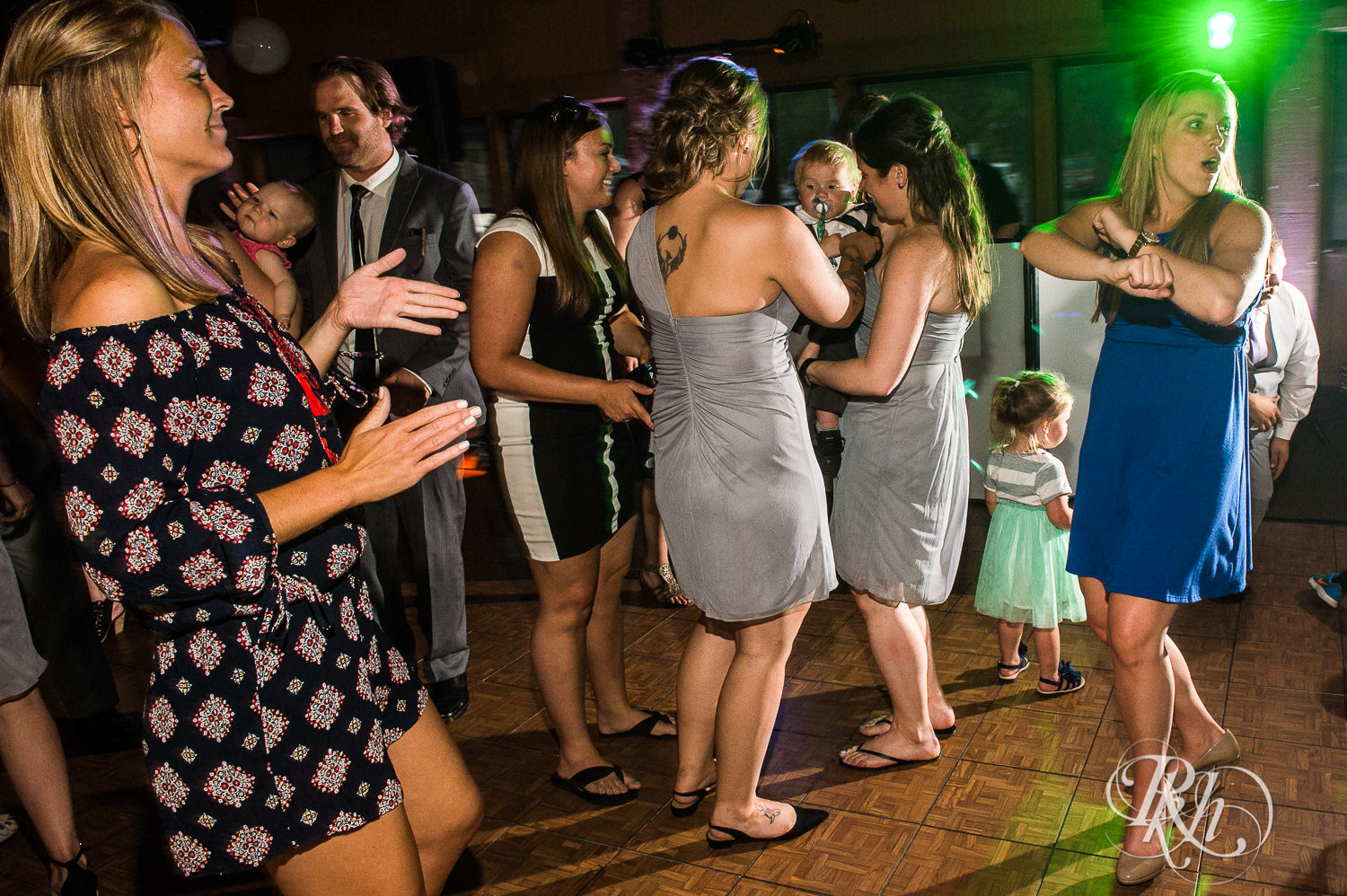 Lesbian brides and guests dance during their wedding reception at Spirit Mountain in Duluth, Minnesota.