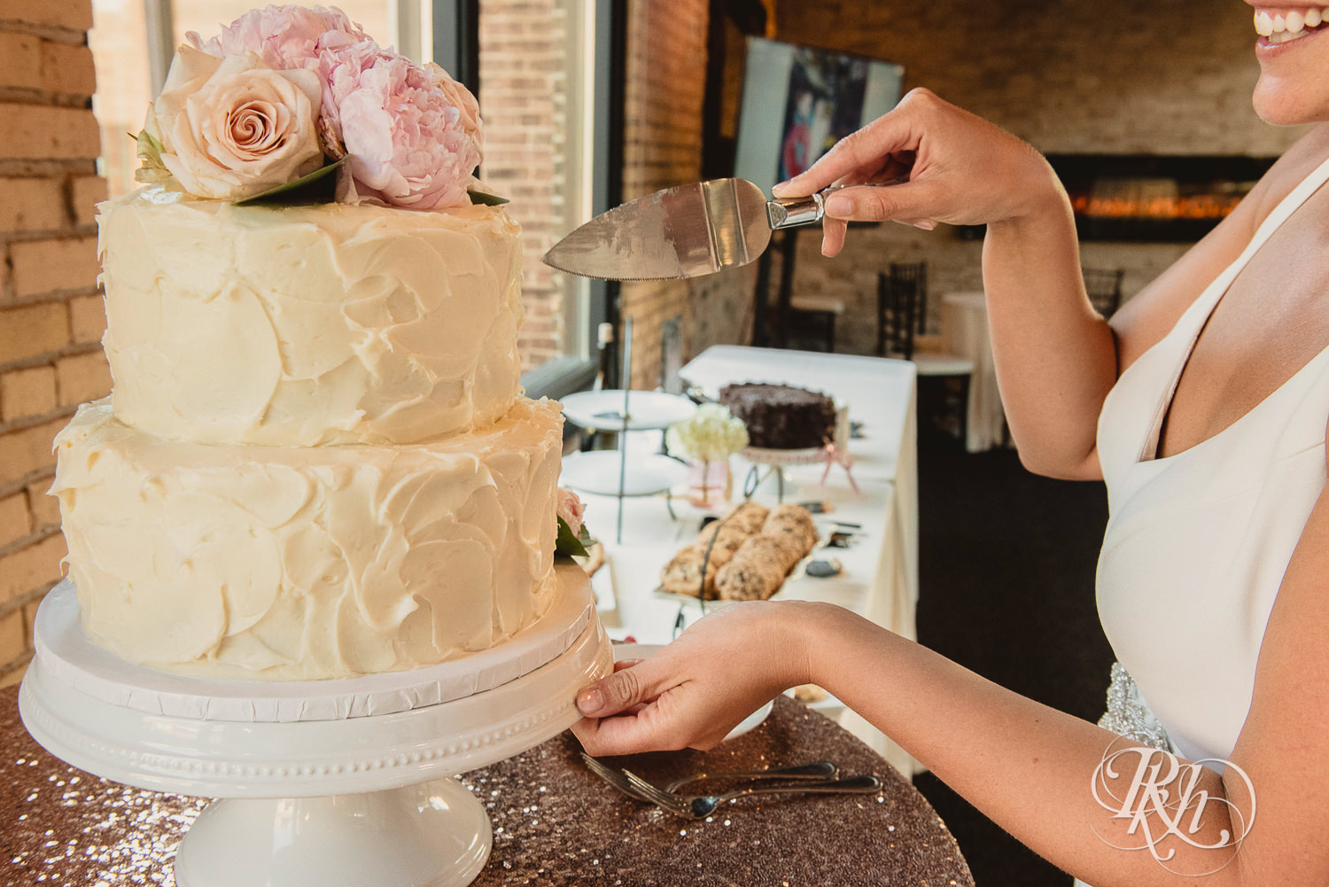 Bride and groom cut wedding cake during wedding reception at Minneapolis Event Centers in Minneapolis, Minnesota.