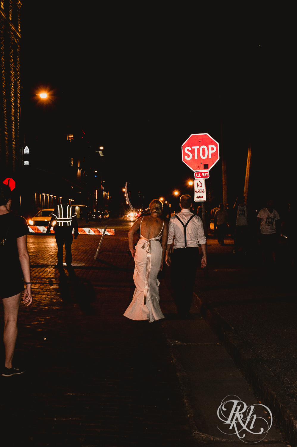 Bride and groom walk down the street at night in Minneapolis, Minnesota.